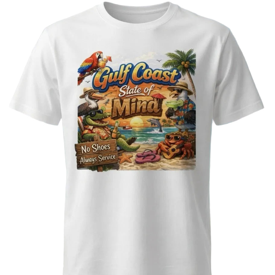 A white short-sleeve crewneck t-shirt featuring a colorful graphic print of a tropical beach scene with the text 'Gulf Coast State of Mind' and a parrot, shown against a beach background.